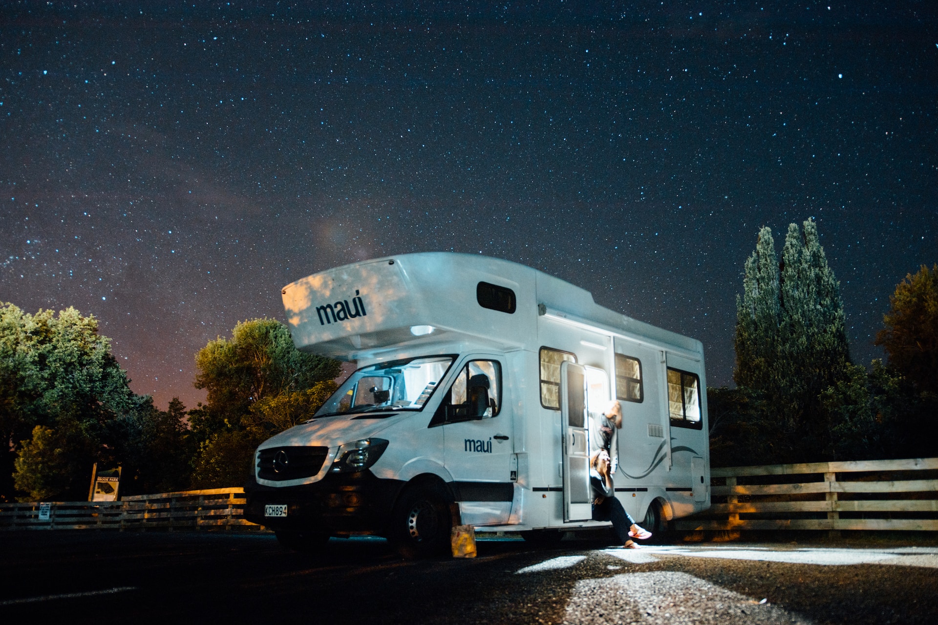 rv lit up against a night sky of stars