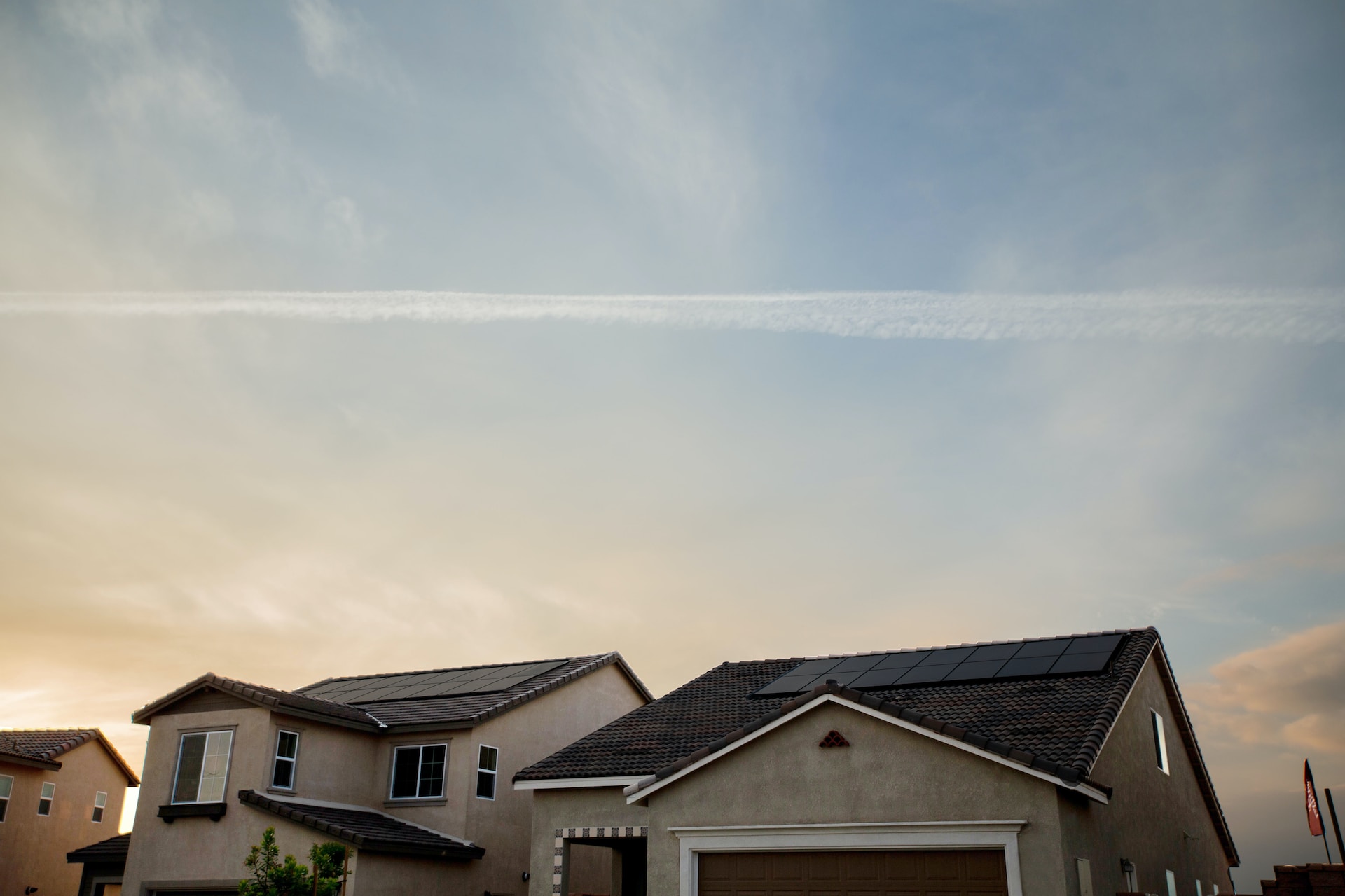 a solar array mounted on a home with sky above it